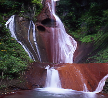 赤い岩肌を流れる美しい滝、オウゼンの滝、旧草津町